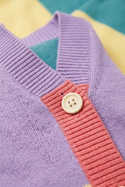 Close-up of cardigan V-neck ribbing and ivory button