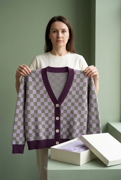 European-style model holding full checker cardigan