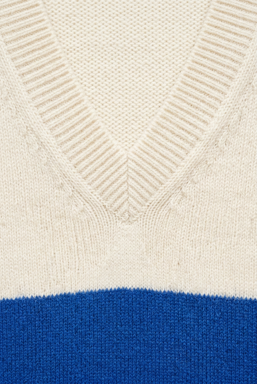 Ivory ribbed V-neck knit detail